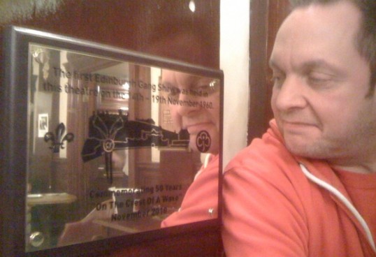     Gang Show director Andy Johnston examines the plaque commemorating 50 years of Gang Shows at the Edinburgh King's