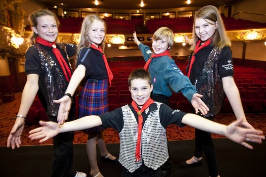 Eilidh Baxter, Lori Stott, Ben Campbell, Joanna Lamb and Michael Denvir (kneeling), members of the 2011 Edinburgh Gang Show cast, on the King’s Theatre stage. Photo: Scott Parker Photography
