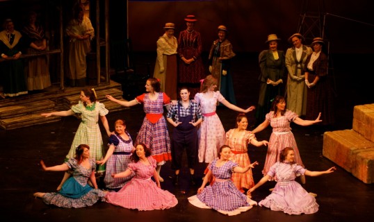 Anna Chidgey (centre, Laurey) with the dance troupe in Many A New Day. Photo © Susan Scott & Crawford Moyes