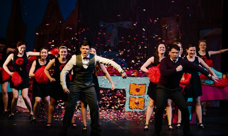 Adam Scott Pringle, Kenneth Pinkerton and cheerleaders. Photo: R. Adam/Edinburgh Music Theatre