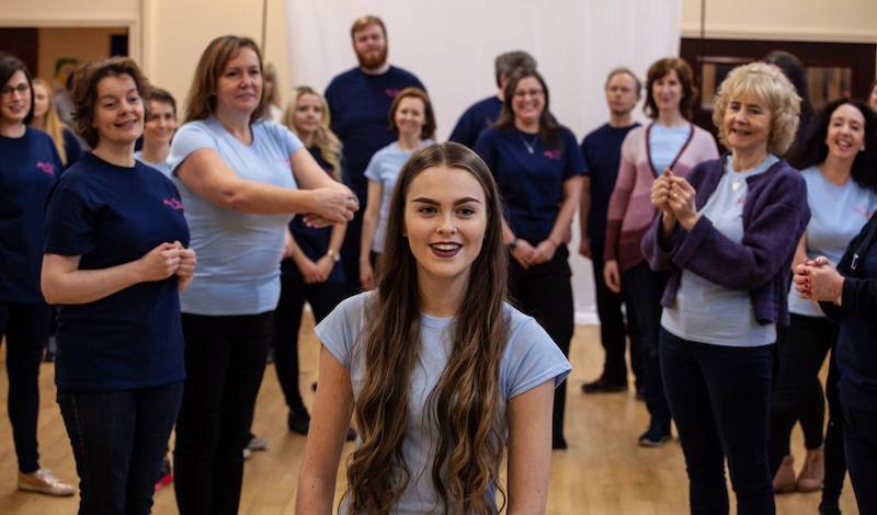 Rebekah Lansley (Eliza) and chorus in rehearsal