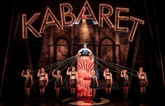 Cabaret Production Photos Bill Kenwright Productions  Book by Joe Masteroff Music by John Kander Lyrics by Fred Ebb Based on the play by John Van Druten & Stories by Christopher Isherwood  Director: Rufus Norris Designer: Katrina Lindsay Choreographer: Javier De Frutos  CAST John Partridge -EMCEE Kara Lily Hayworth -SALLY BOWLES Anita Harris - FRÄULEIN SCHNEIDER Charles Hagerty - CLIFF BRADSHAW James Paterson - HERR SCHULTZ Nick Tizzard - ERNST LUDWIG Basienka Blake - FRÄULEIN KOST Catherine Saunders - ENSEMBLE Oliver Roll - ENSEMBLE Sara Morley - ENSEMBLE Joseph Dockree - ENSEMBLE Gemma Archer - ENSEMBLE Sophie Hirst - ENSEMBLE Mary Hodgkinson - ENSEMBLE Hannah Nicholas - ENSEMBLE Ben Rutter - ENSEMBLE Francis Foreman - ENSEMBLE Tom Scanlon - ENSEMBLE  ©The Other Richard