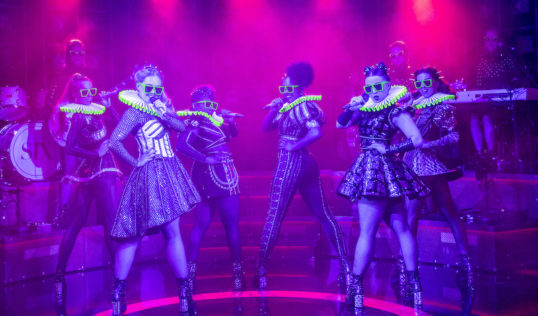 Kat Bax on Bass, Jodie Steele as Katherine Howard, Lauren Byrne as Jane Seymour, Shekinah McFarlane as Anna of Cleves, Athena Collins as Catherine Parr, Maddison Bulleyment as Anne Boleyn, Frankie South on Guitar, Lauren Drew as Catherine of Aragon, Arlene McNaught as Musical Director/Keyboard