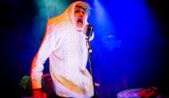 Ruxy Cantir wears a big white Arran jumper, pulled up over her head. A big white onion, spitting rhymes into an old fashioned microphone.