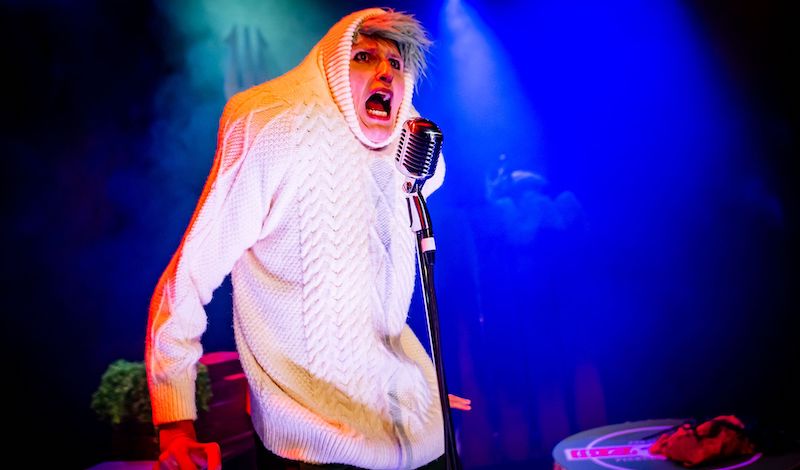 Ruxy Cantir wears a big white Arran jumper, pulled up over her head. A big white onion, spitting rhymes into an old fashioned microphone.